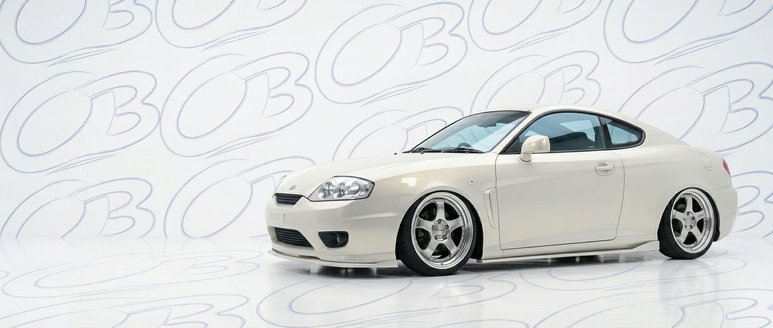 Professional automotive photography of a 2001 Hyundai Tiburon with high-fidelity 2001.