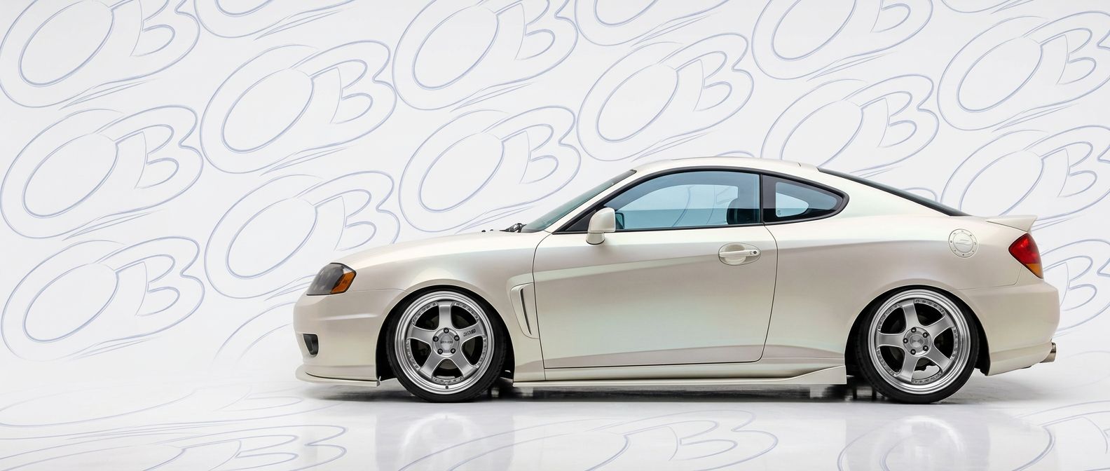 Front-angle view of 2004 Hyundai Tiburon 2004 - Durable and stylish exterior enhancement.