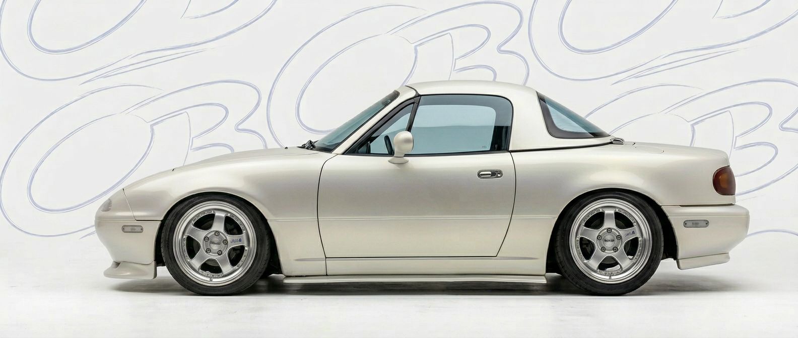 Professional automotive photography of a 1991 Mazda Miata with high-fidelity 1991.