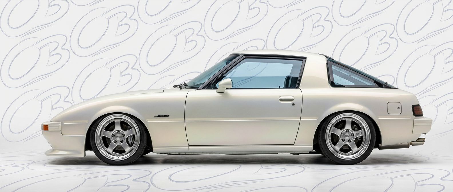 Professional automotive photography of a 1985 Mazda RX-7 with high-fidelity 1985.