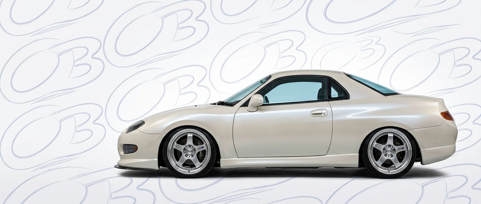 Top-tier 2000 Mitsubishi FTO 2000 featuring a high-gloss finish and carbon fiber weave.