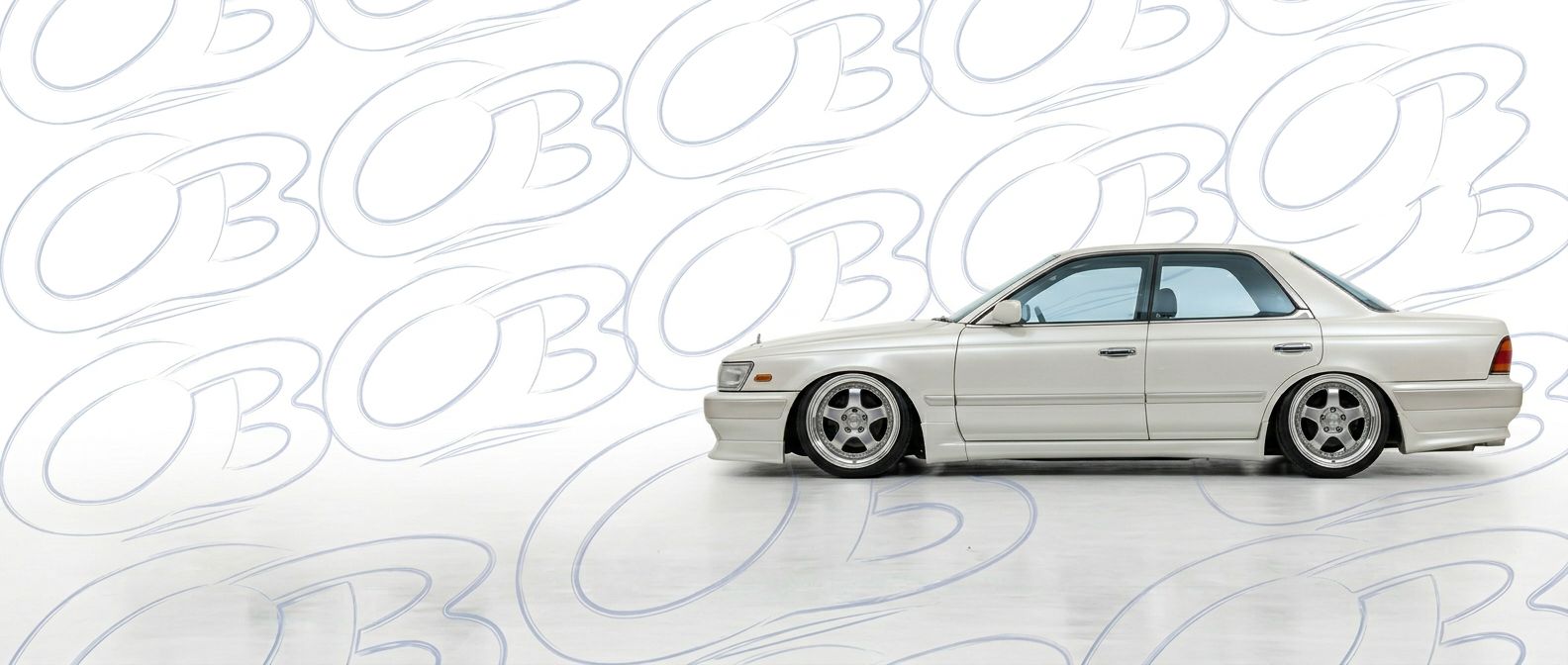 Professional automotive photography of a 1990 Nissan Laurel with high-fidelity 1990.