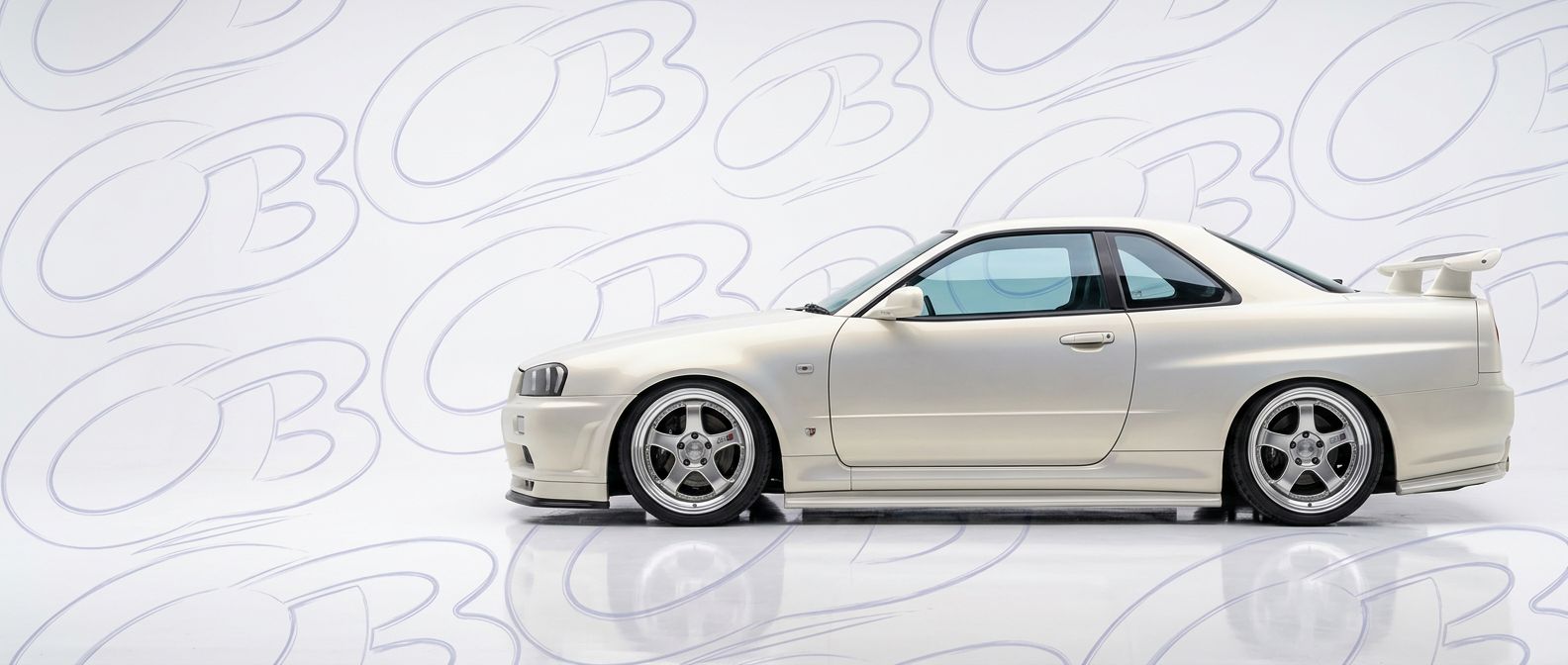 Professional automotive photography of a 2001 Nissan Skyline (R34) GTS with high-fidelity 2001.