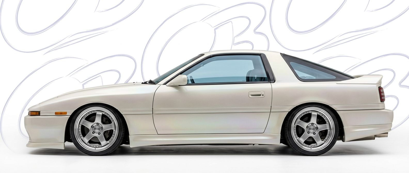 Professional automotive photography of a 1990 Toyota Supra with high-fidelity 1990.